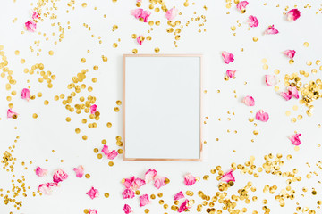 Photo frame mock up with space for text, pink rose petals and golden confetti on white background....