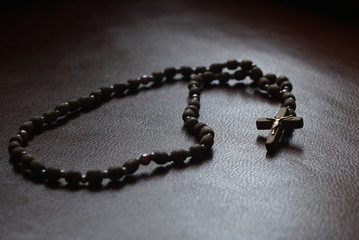 The rosary on a leather sofa, close