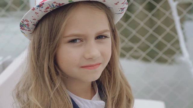 Unsurpassed little model in hat turns and looks at camera 4K