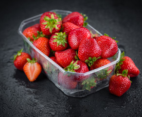 Some Strawberries on a dark slate slab