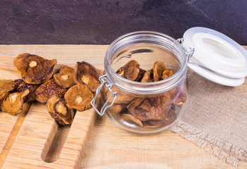 Dried forest mushrooms on a wooden table.
