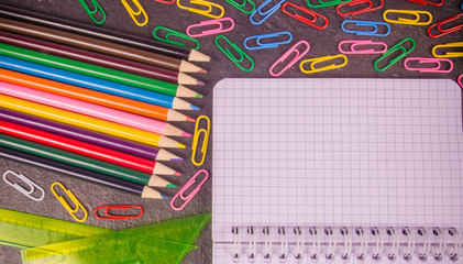School supplies on black background ready for your design.