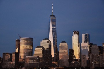 The Freedom Tower, World Financial Center, and the skyline of downtown Manhattan from Jersey City at dusk.