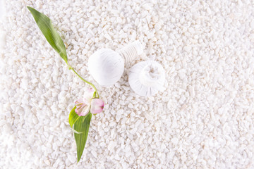 Alstroemeria and floral balls on a background of white pebbles.