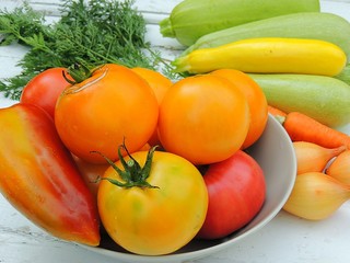 Organic fresh vegetables, ingredients for preparing food on linen tablecloth, vintage wooden background.