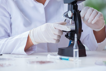 Female scientist researcher conducting an experiment in a labora