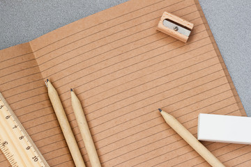 Open craft notebook, wooden stationery items , top view. Concept for education, workplace, back to school, copy space