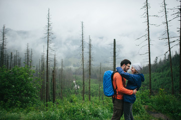 Traveler couple in love enjoying the mountains