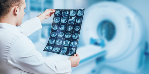 Doctor looking MRI picture. - obrazy, fototapety, plakaty