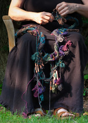 Hands knitting with yarn bobbins