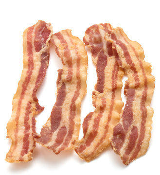 cooked crispy slices of bacon isolated on white background