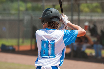 Teen baseball player at bat