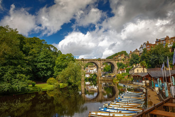 Low-angle telephoto shot of the medieval town of Knaresborough, Yorkshire, England, UK showing the railway viaduct and river Nidd