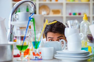 Man frustrated at having to wash dishes