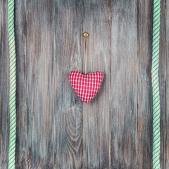 Valentine love heart shape and rope on vintage old grunge textured wooden planks wall background. Retro style filtered photo