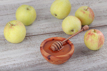 Honey in wooden bowl with honey dipper