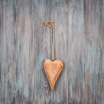 Valentine love heart shape on vintage old grunge textured wooden planks wall background. Retro style filtered photo