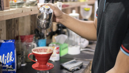 A man makes coffee with the v60 method