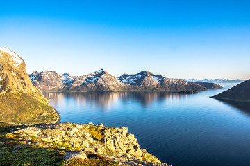 Fjord mountain midnight sun blue water and sky