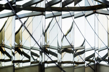 Reflections and optical effects of space distortion on the glass facade of a modern building. Abstract Architecture Background