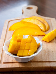 Small plate with mango on a wooden board