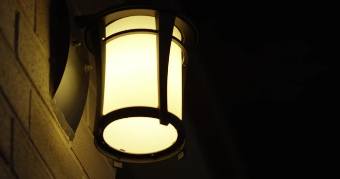 Lamp on birck wall at night