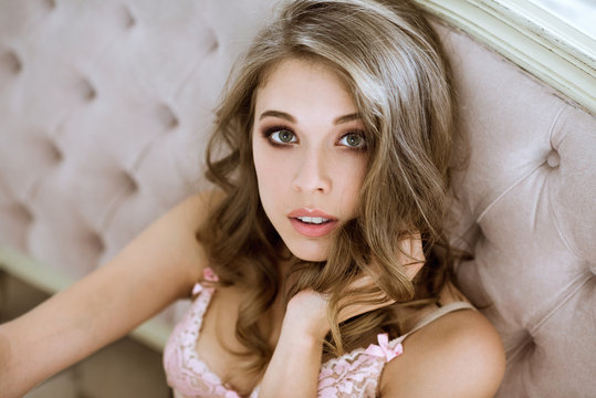 Fashionable female portrait of cute lady in pink bra indoors