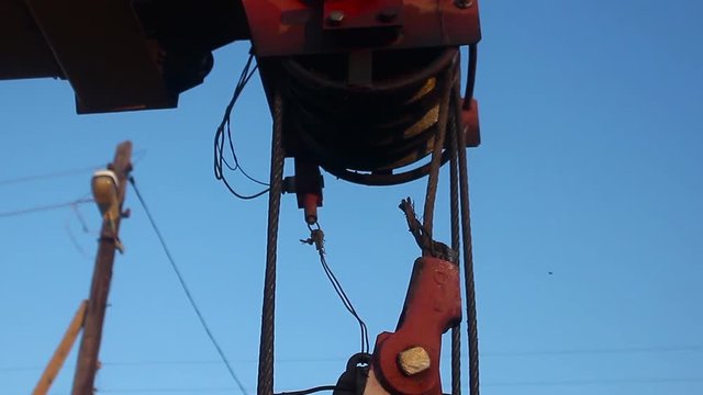 yellow automobile crane with rise n telescopic boom outdoors over blue sky