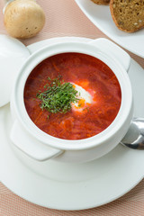 Borscht with sour cream in pot