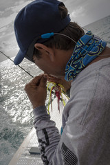 Mexican Big Game Fishing Guide Tying a Fly with Teeth While Baiting a Hook