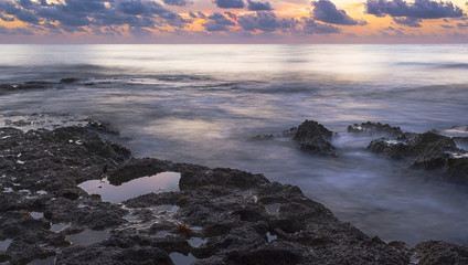 Early Morning Sunrise Over Rocky Coastline in Gulf of Mexico
