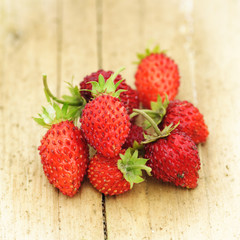 wild strawberries on a wooden table