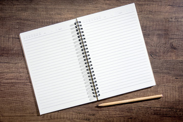 Top view notebook paper on wooden background. Concept for business and education.