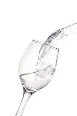 Shot of water (vodka) falling into a glass.