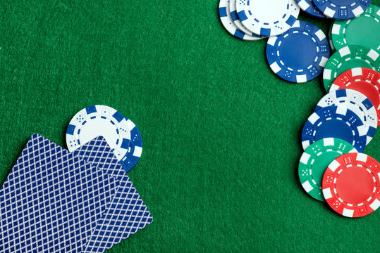 Casino green table with chips and play cards