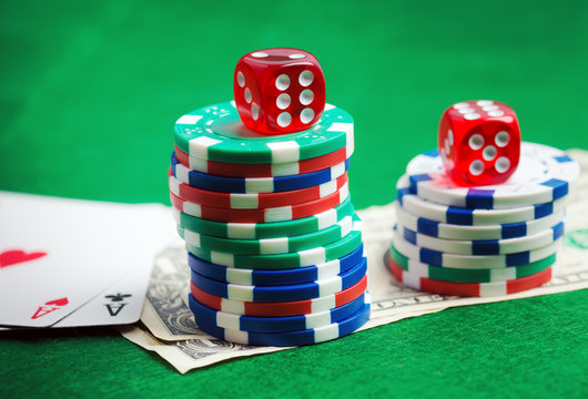 Casino green table with chips, money and dices