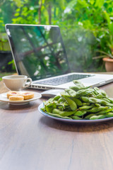 Top view home office table with laptop, coffee and cookie on wooden table. Modern office top view at home. New life style. Concept : business and office.