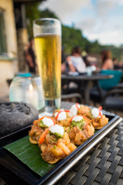 Indian Local food  fusion on the wood plate with beer for outdoor restaurant dining in Rock Bar, Bali, Indonesia