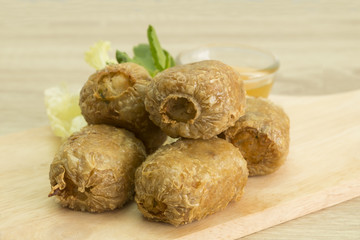 FRIED CRAB DUMPLING ON CUTTING BOARD
Fried crab dumpling on cutting board with sweet and sour sauce.