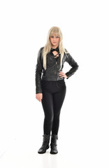 Fototapeta premium full length portrait of blonde girl wearing black leather outfit, standing pose on white background.