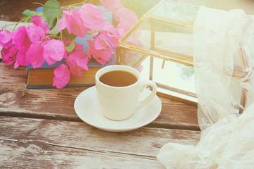 cup of coffee on old wooden table outdoor in the park