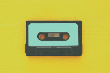 Retro cassette tape over yellow wooden table. top view. copy space