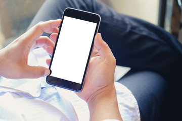 Business man using smartphone in office. Blank screen mobile phone for graphic display montage.