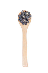 Black goji (black wolf berry) in a wooden spoon.