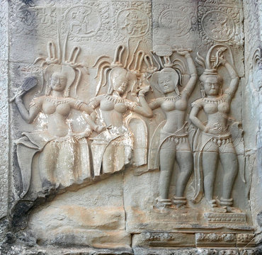 Dancing Apsaras an old Khmer art carvings on the wall in the corridors of Angkor Wat temple Siem Reap Cambodia.