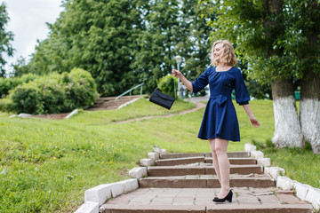 Young attractive blond woman in a summer park