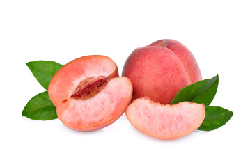 whole and half of peach with green leaves isolated on the white background