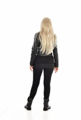full length portrait of blonde girl wearing black leather outfit, standing pose on white background.