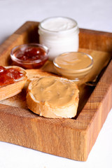 Fototapeta na wymiar Bread toast with jelly jam and peanut butter. Sandwich for breakfast