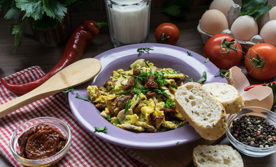Scrambled egg with dried tomatoes and home baked goods